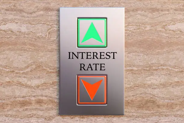 Photo of The word INTEREST RATE engraved between up and down lift buttons on a marble wall. Illustration of the concept of fluctuation and forecast of interest rate