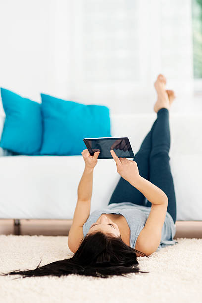 istock Young woman using tablet on the floor 163218567