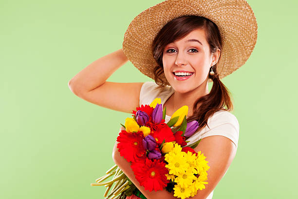 istock Smiling brunet woman with hat and spring flower 163218616