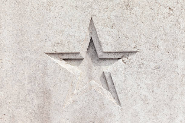 star shape detail carved into a concrete wall - gray stucco background
