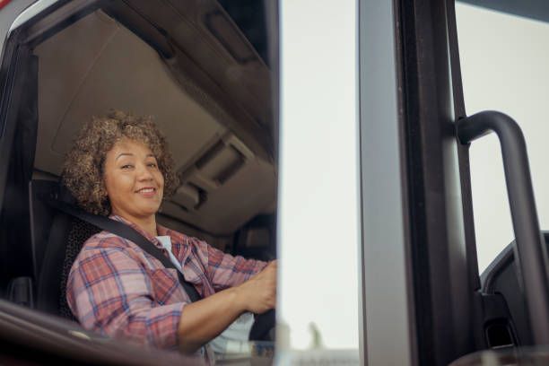 istock Female Truck Driver Reflected in the Rearview Mirror 1632196701