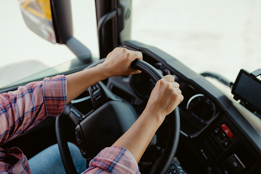 Driver of Semi-truck Sitting and Drining Her Vehicle