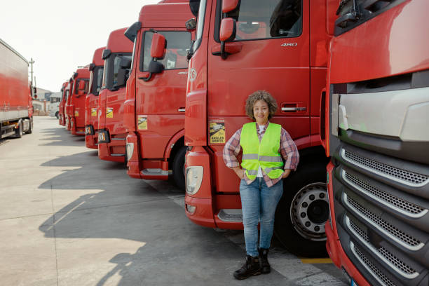 istock Female Professional Truck Driver Looking at Camera 1632197312