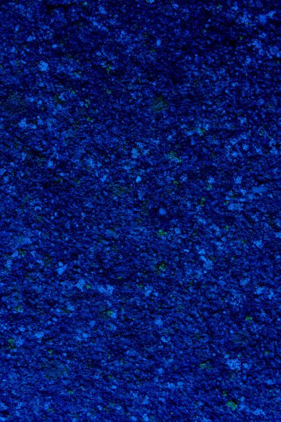 istock Dark blue background abstract texture with green and light-blue granules. 1632197820