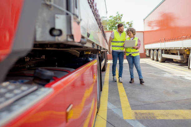 istock Lorry Driver Controlling Truck Driver Schedule With Laptop 1632197878