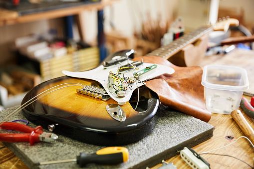 Electric guitar disassembled in a luthier's repair workshop