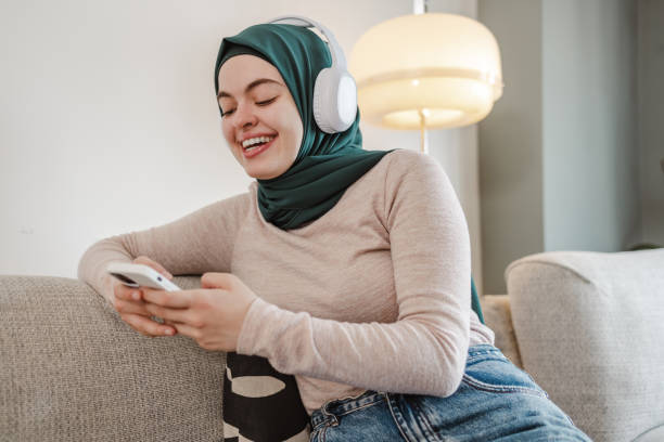 istock A young Asian woman laughing while using her phone 1632217298