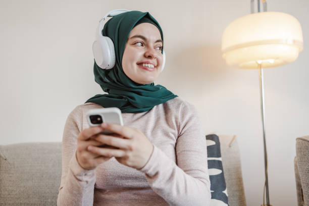 istock A young Asian woman cheerfully looking away while holding her phone 1632217849