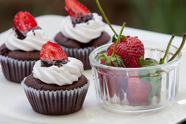 Chocolate Cupcake with strawberry On white dish.
