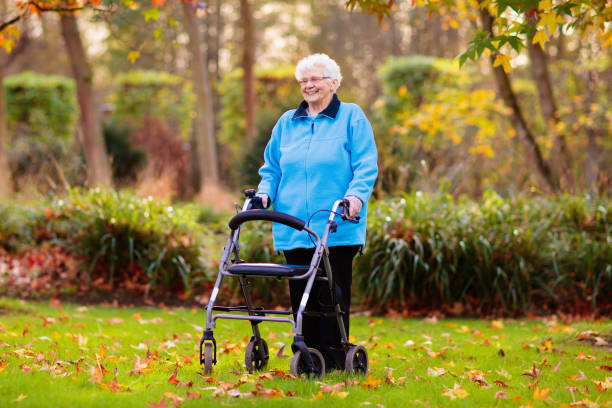 istock Senior lady with a walker in autumn park 1632299110