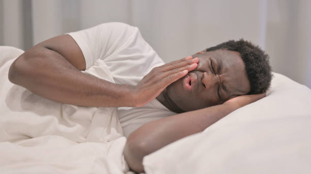istock African American Man with Toothache Lying in Bed on Side 1632314830