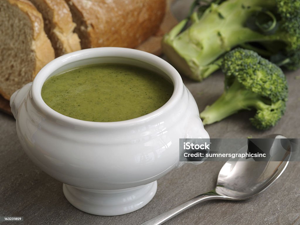 Broccoli soup Photo of broccoli soup with a loaf of bread in the background. Appetizer Stock Photo