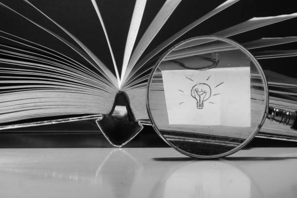 istock Open book, hardback book magnifying glass and light bulb. Back to school,education,knowledge,reading. free Copy space 1632322210