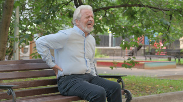 istock Senior Old Man Sitting Outdoor with Back Pain 1632373573