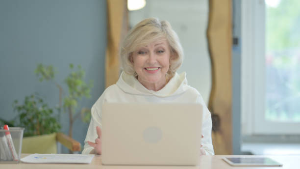 istock Senior Old Woman Doing Online Video Chat on Laptop 1632376664