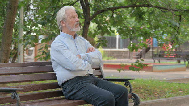 istock Serious Senior Old Man Sitting Outdoor 1632377690