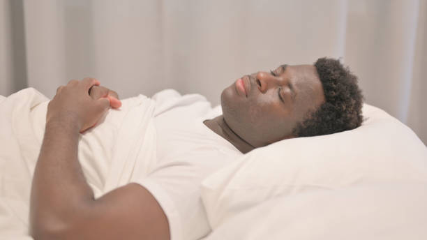 istock Side View of African American Man Sleeping in Bed 1632406177