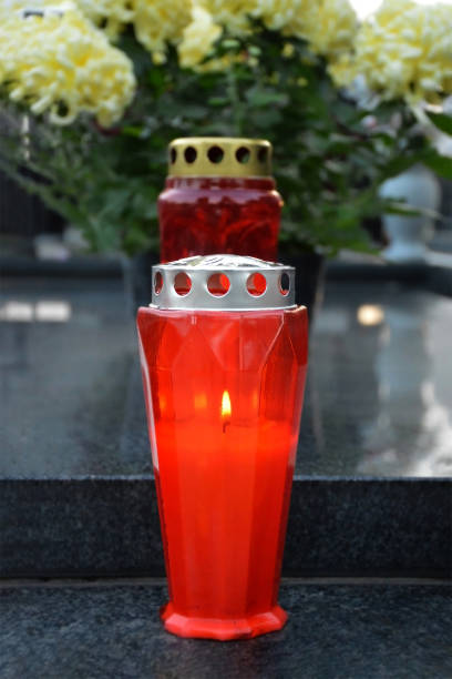 istock Red votive candle on the grave 1632415289