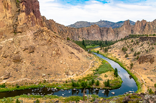 crooked river winding through large mountains and rocks in Smith Rock state park, OR