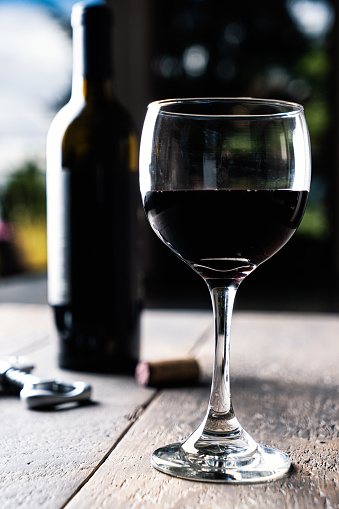 Red wine in a glass on a wooden table