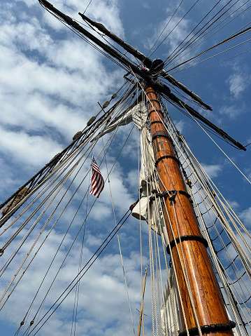 The Friends Good Will tall ship is a replica of an 1810 top sail merchant sloop at the Michigan Maritime Museum in South Haven, Michigan. This is a view upwards before the sails are opened up on a beautiful summer day on the water.