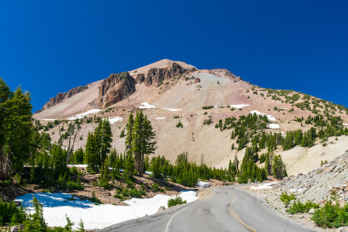 Open road heading towards mountain in Lassen Volcanic National Park, CA