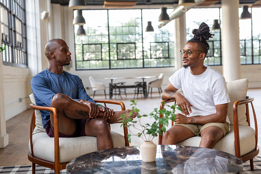 African American men and women participate in tasks centering their mental health and wellbeing such as meditation, yoga, small group conversations with friends and community, repotting plants and journaling