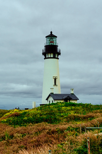 Newport, OR / USA - 3 JUL 2022: Yaquina Head Lighthouse stands tall to alert ships of land