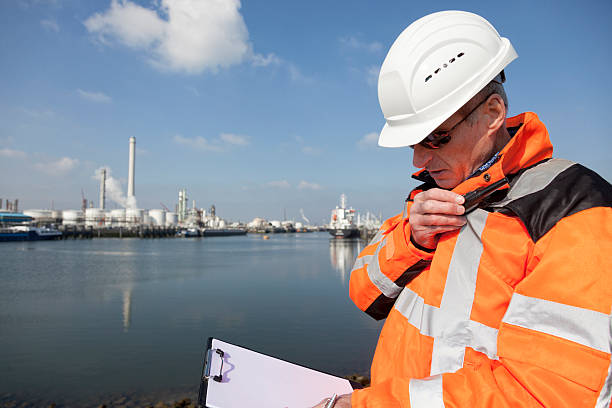 Dockworker Dockworker talking in radio   chemical worker stock pictures, royalty-free photos & images