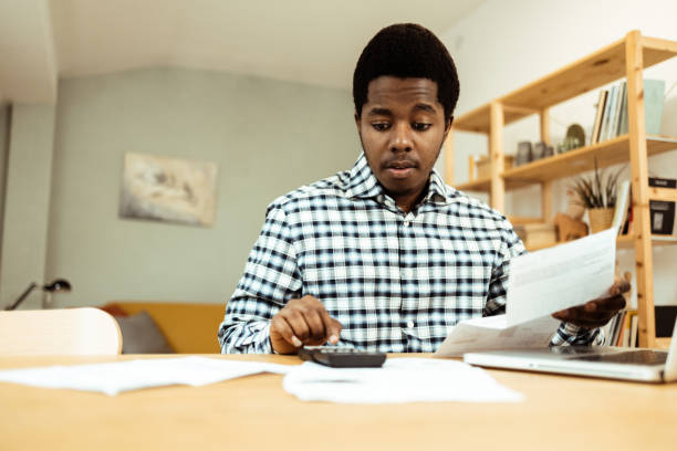 istock Young African American managing expanses at home 1632525030