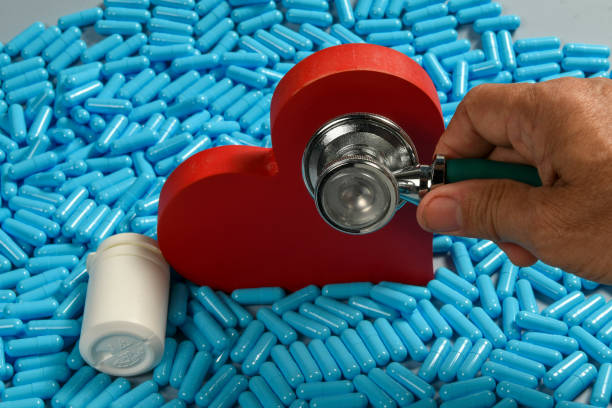 istock heart shape and medicine capsules representing heart problems and treatment 1632566305