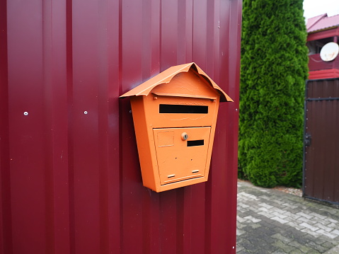 Mailbox on the red metal wall. postbox for correspondence.
