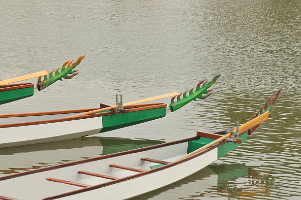 Daugavpils, Latvia July 20, 2024 Dragon boat races, colorful rowing competition. Teamwork in traditional rowing festival of water sports in Latvia. Ornate boats with carved dragon head on city lake attract many people to watch dynamic vivid competition
