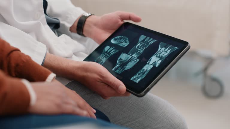 Doctor, patient hands and tablet for xray video, muscle results and healthcare anatomy solution or skeleton review. Medical, professional people for radiology advice, x ray graphic and digital screen