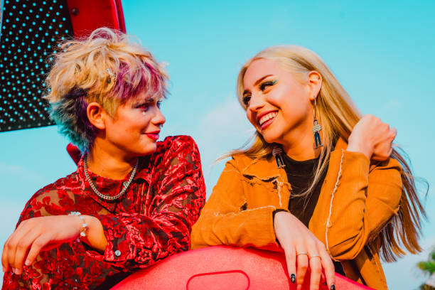 istock Young female friends looking at each other and smiling. 1632595466