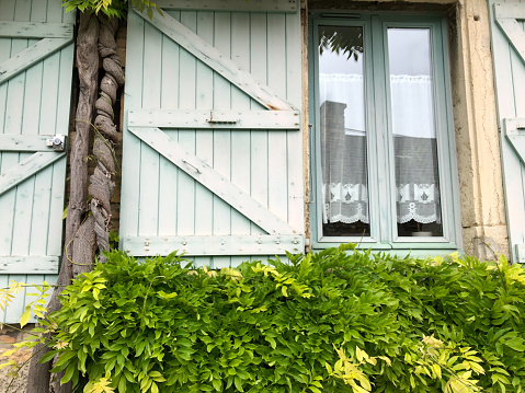 Crémieu, France: Charming Window with Lace Curtains (Close-Up)