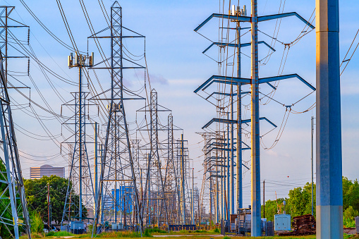 A large array of high power electricity transmission lines bringing power to the Houston, Texas region.