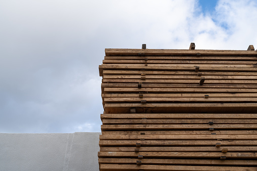 wooden planks stored outside in a warehouse
