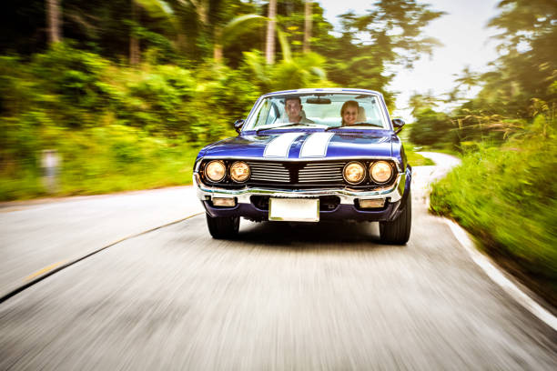 istock Couple driving retro car down the road 163265508