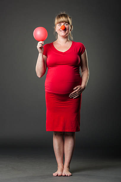 Portrait Of Funny Pregnant Woman In Red Dress Stock Photo - Download Image  Now - Abdomen, Adult, Adults Only - iStock