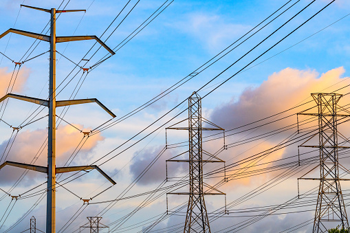 High-voltage transformer substation in winter at dawn. High voltage equipment. Energy transfer technology.