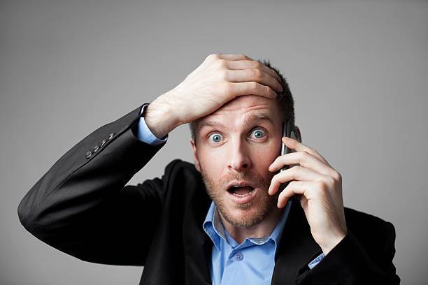 istock Shocked businessman talking on the phone 163268298