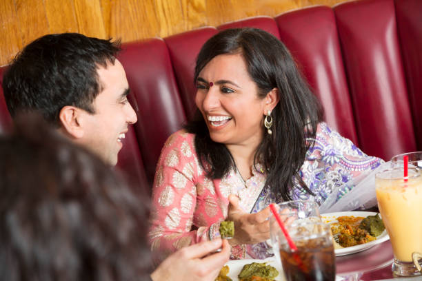 istock Happy indian couple laughing at the restaurant 163269488