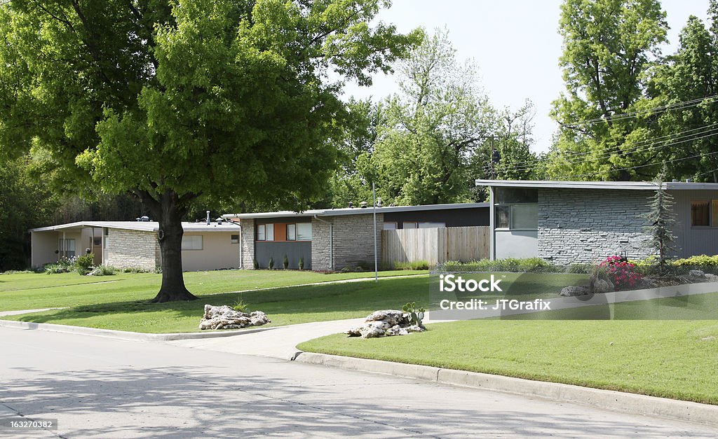 Three American Homes-Mid Century Flat Roof Houses Three flat roof houses built in the 1950's are photographed in a neighborhood. 1950-1959 Stock Photo