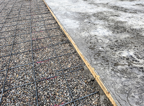 reinforcing steel on on left, poured cement on right