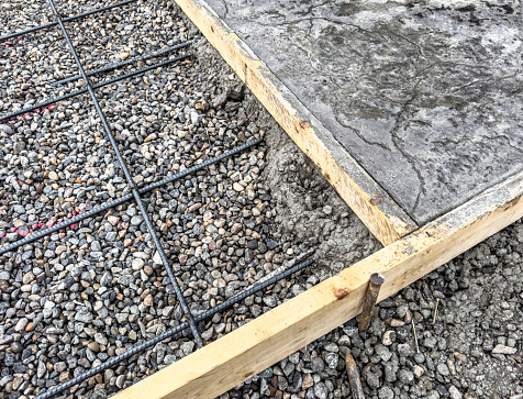 reinforcing steel on on left, poured cement on right