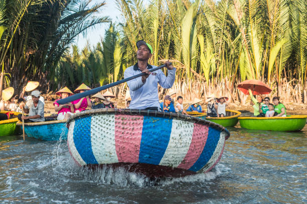 funny coconut tour at vietnamese river hoi an, vietnam. 16th june, 2023: coconut boat tour at cam thanh village, vietnam basket boat stock pictures, royalty-free photos & images