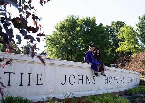 Baltimore, MD, USA-A couple of graduates taking photos at the Johns Hopkins University campus