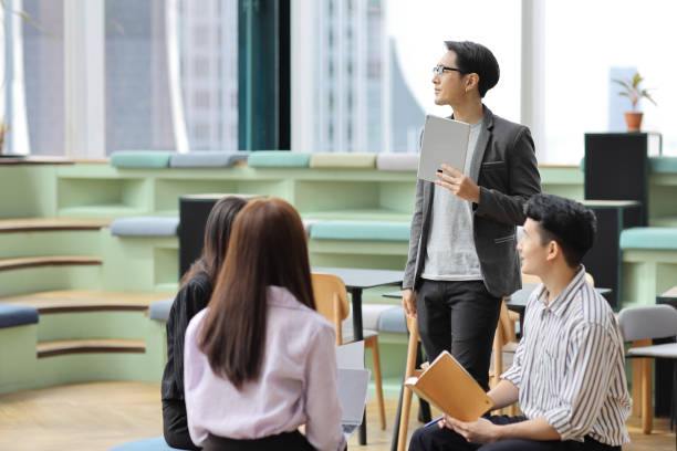 istock Collaborative process of young asian business people team working together discussing, researching, brainstorming and planning work at business meeting in modern office building and city background 1632886746