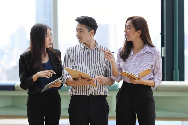 istock Collaborative process of young asian business people team working together discussing, researching, brainstorming and planning work at business meeting in modern office building and city background 1632887835